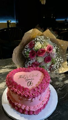 two heart shaped cakes on a table with flowers in the center and congratulations written on top