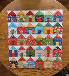 a close up of a wooden table with a quilt on it