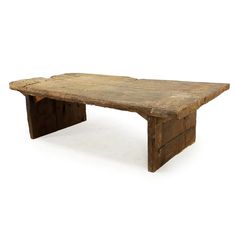 an old wooden table with no one around it on a white background in the image