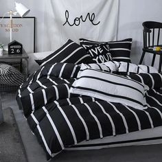 black and white bedding in a bedroom with a love sign hanging on the wall