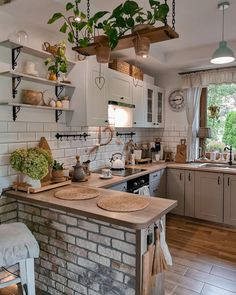 a kitchen filled with lots of pots and pans on top of a brick wall