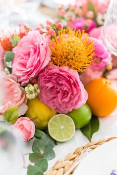 flowers, lemons and limes are arranged on the table for a wedding reception