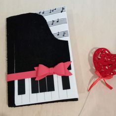 a book with a red heart on it next to a musical note and a string