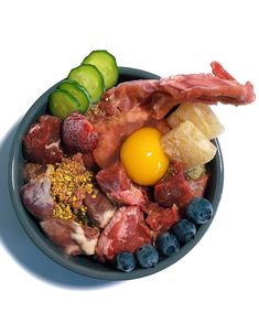 a bowl filled with meat, vegetables and an egg