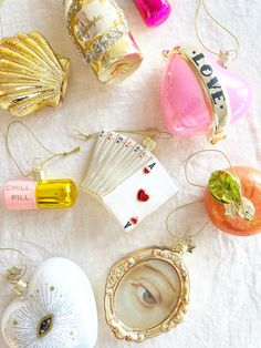 various ornaments are laid out on a white tablecloth, including cards and seashells