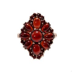 "Handcrafted in the 1990s, this exquisite pyrope garnet ring boasts an array of carbuncles, also known as garnet cabochons, elegantly complemented by round-cut garnets. The cluster arrangement forms a captivating floral motif, and when kissed by sunlight, the garnets emit a radiant, enchanting glow. This charming vintage ring, adorned with garnets and plated in rose gold vermeil, makes a delightful addition to your jewelry collection. Garnet jewelry has a rich history dating back thousands of ye Garnet Ring Gold, Pyrope Garnet, Demantoid Garnet, Garnet Gem, Antique Brooches, Garnet Jewelry, Cabochon Ring, Garnet Ring, Garnet Rings