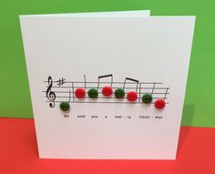 a card with musical notes on it and red buttons attached to the front of each card