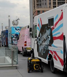 a line of food trucks parked next to each other