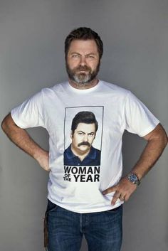 a man standing with his hands on his hips wearing a t - shirt that says woman of the year