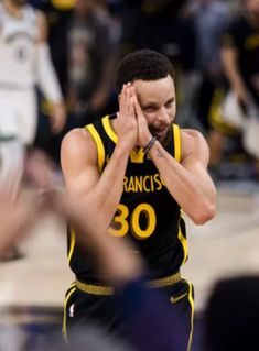 the basketball player is applauding his team's fans in front of him