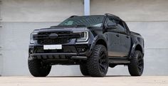 a black truck parked in front of a building