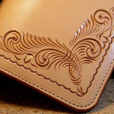 a brown leather wallet sitting on top of a table