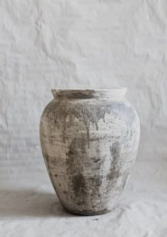 a white vase sitting on top of a table