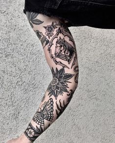 a man with tattoos on his arm and leg