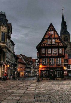 an old european town with tall buildings and cobblestone streets