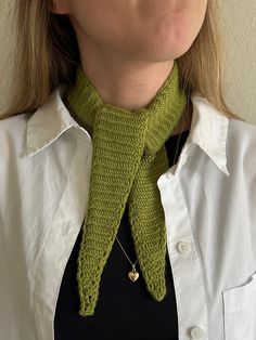 a woman wearing a green knitted neck tie