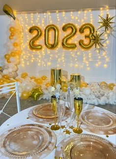 the table is set with champagne glasses, plates and silverware for an elegant new year's eve celebration