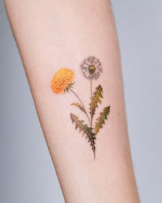 a flower tattoo on the left arm with leaves and flowers painted on it's side