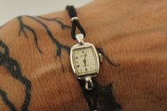 Pretty vintage women's Gruen Precision wrist watch circa the 1950s or so.  The face is white and marked with Gruen precision and Swiss on the face. Case is marked with 10K GF. Band is black leather, I believe. It is working.   Excellent vintage condition. Typical signs of age, such as small dings to the case and wear to the metal.  Please note: These are vintage, preworn and/or preloved items. I do my utmost best to list any issues, but signs of wear should be expected, and there are occasionally small things I won't deem worthy of note. Please feel free to send me a missive with any questions. I'm truly happy to help in any way possible and I'm always up for a chat. Any accessories shown, including crinolines, are for display only, not included unless otherwise stated. I lovingly curate a Small Band, Dark Look, Women Wrist Watch, Wrist Watches, 10k Gold, Womens Watches, The Face, Wrist Watch, Gold Filled