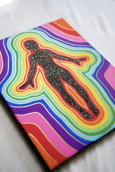 a colorful art piece with a person silhouette on the front and rainbow swirls in the back