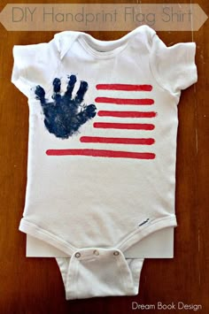 a baby bodysuit with an american flag painted on it and the words diy handprint flag shirt