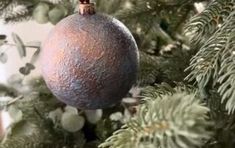 an ornament hanging from the top of a christmas tree