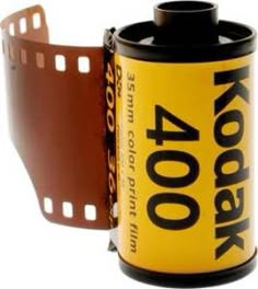 a roll of film sitting on top of a can with the word kodak printed on it