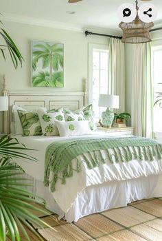 a green and white bedroom with palm trees