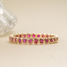 Nyra Ruby is a stone of royalty, highly coveted for its rich red hue. This can be your vibrant and unique wedding band, yet also the perfect dainty ring to add a pop of color to your solid gold ring stack. This is a full eternity band surrounding the entire finger. Choose your metal and size, and we will make it custom for you. July’s birthstone, this is a stunning ring to stack with your wife’s wedding ring! - Handmade- Solid Gold- Natural Ruby- Total Ruby Carat Weight: 1 ctw for size 6.5- Widt Ruby Eternity Ring, Ruby Eternity Band, Ruby Wedding Band, July Birthstone Ring, Ruby Bands, Stackable Bands, Full Eternity Ring, Handmade Fine Jewelry, Ring Stack