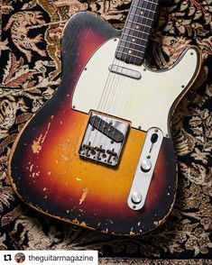 an old guitar sitting on top of a rug