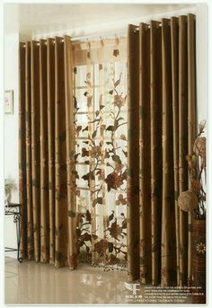 the curtains in this living room are decorated with flowers and leaves, while the window is closed