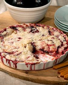 the pie is ready to be eaten on the wooden table with other plates and utensils