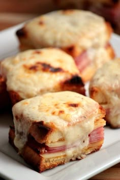 some ham and cheese sandwiches on a white plate