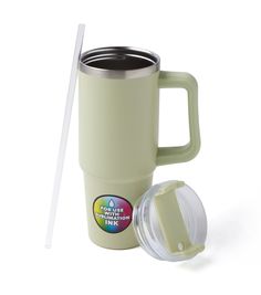 a coffee cup with a straw and lid next to it