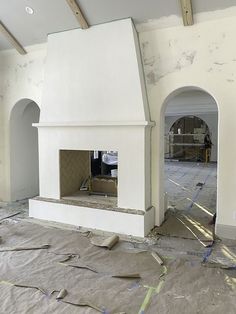 an unfinished room with a fireplace in the middle