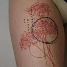 a woman's thigh with flowers on it and the words written in cursive writing