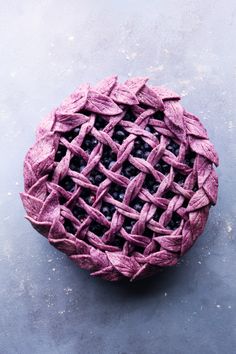 a blueberry pie on a gray surface