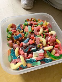 a plastic container filled with lots of colorful candy