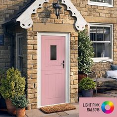 a pink front door on a brick house