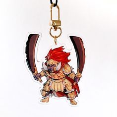 a keychain with an image of a red headed demon holding two large swords