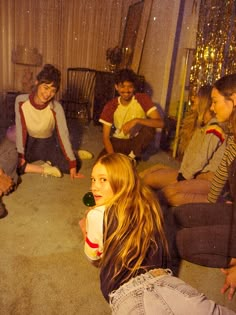 a group of young people sitting around each other