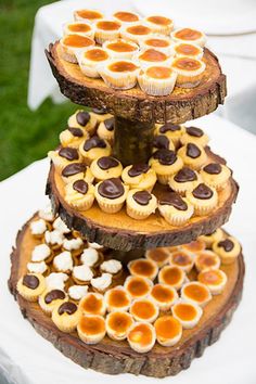 three tiered dessert display with cupcakes on top