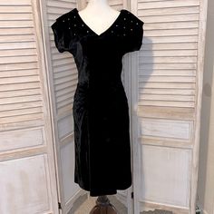 All Orders Ship In 1-2 Business Days! Regal 1950’s Black Velvet Cocktail Dress From Filene’s Boston Department Store. The Dress Is Fitted With Gathering At The Waist To Accentuate An Hourglass Figure. It Is Accented With Rhinestones Along The Top Collar. Conditions: Great Vintage Condition/Clean Condition/No Holes/No Stains/No Pilling/No Fade The Color Is Black Size Small Bust: 18” Waist: 13” Hips: 18” Length: 39.5” *Measurements Are Approximate. Measurements Were Taken With The Garment Laying F Black Velvet Cocktail, Velvet Cocktail Dress, Kick Pleat, Velvet Material, Small Bust, Department Store, Black Velvet, Sheath Dress, Dresser