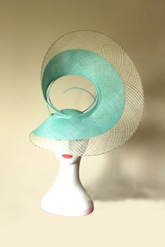 Hat Title - The Swirl (in green and ivory) An architectural shape that sits proud on the head of the wearer. Handmade with mint sinamay and outlined with checkered windowpane in ivory. The back of this hat is equally unique. Each angle of the hat looks different, providing different perspectives to the viewer. The hat adheres to your head via a millinery elastic.  This hat and almost all of my hats can be made in colours of your choice. Message me to discuss. The last photo shows this hat in Black and Gold. Luxury Green Wedding Costume Hats And Headpieces, Green Headpiece For Church, Elegant Green Headpiece For Church, Elegant Green Mini Hat With Curved Brim, Vintage Green Mini Hats For Summer, Elegant Green Costume Hat For Royal Ascot, Green Curved Brim Costume Hat For Summer, Green Summer Costume Hats And Headpieces For Church, Fitted Green Hat