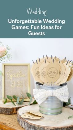 a wooden table topped with vases filled with paper flowers and cards that say,'unforgettable wedding games fun ideas for guests '