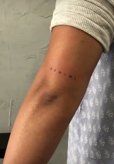 a person with a small tattoo on their arm