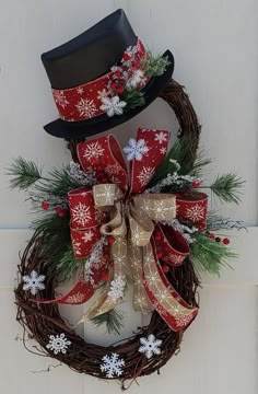 a wreath with a top hat on it and snowflakes hanging from the front