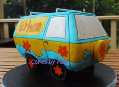 a cake shaped like a van is sitting on a table