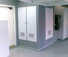 an empty room with white and grey lockers