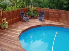 a wooden deck next to a swimming pool